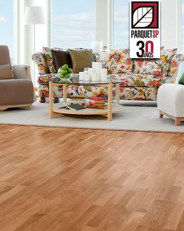 A imagem mostra uma sala de estar com várias poltronas e o piso de madeira.
