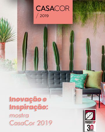 Ao fundo da imagem, há uma sala com sofá, mesa e caquitos de decoração.