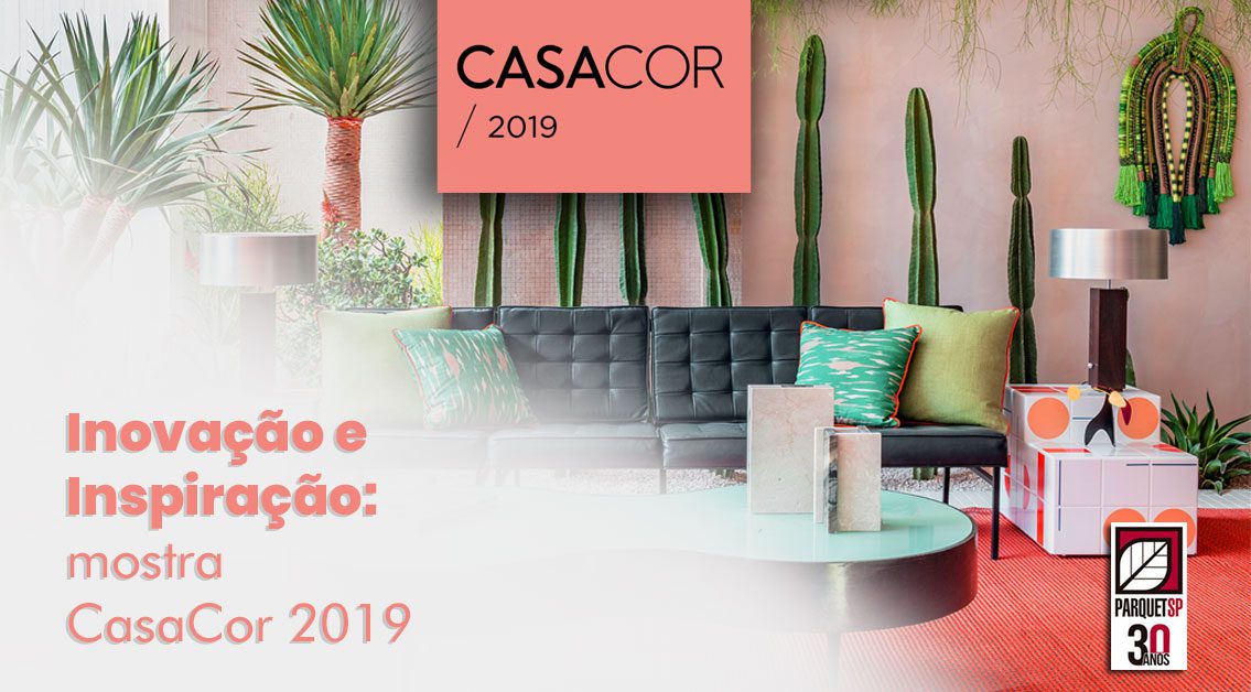 Ao fundo da imagem, há uma sala com sofá, mesa e caquitos de decoração.