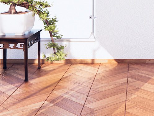 Imagem mostra um piso de madeira. uma mesa com um planta e um raio de sol entrando.